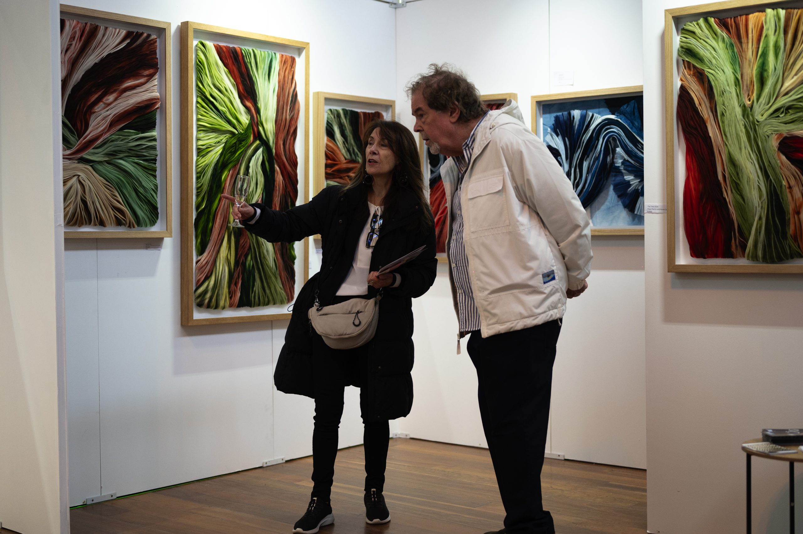 Image of art buyers walking around pointing at art