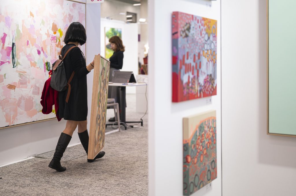 Carrying art home. How to Buy Art at Affordable Art Fair.